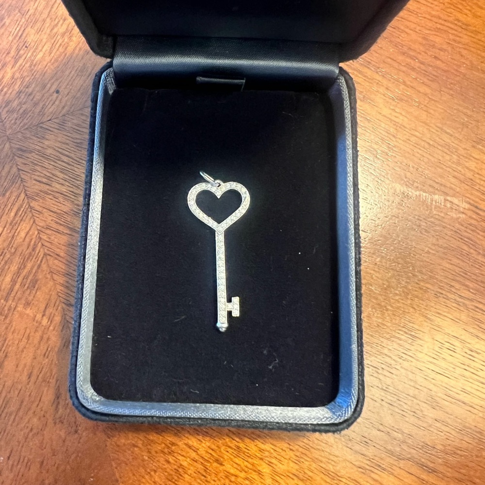 Tiffany & Co. Platinum & Diamond Heart Key Charm
NBW 
Pristine condition